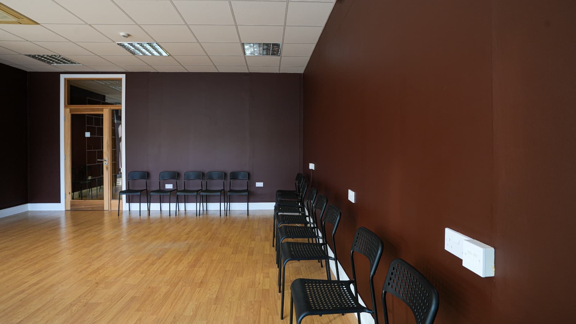 The main studio set up with chairs along the cocoa walls